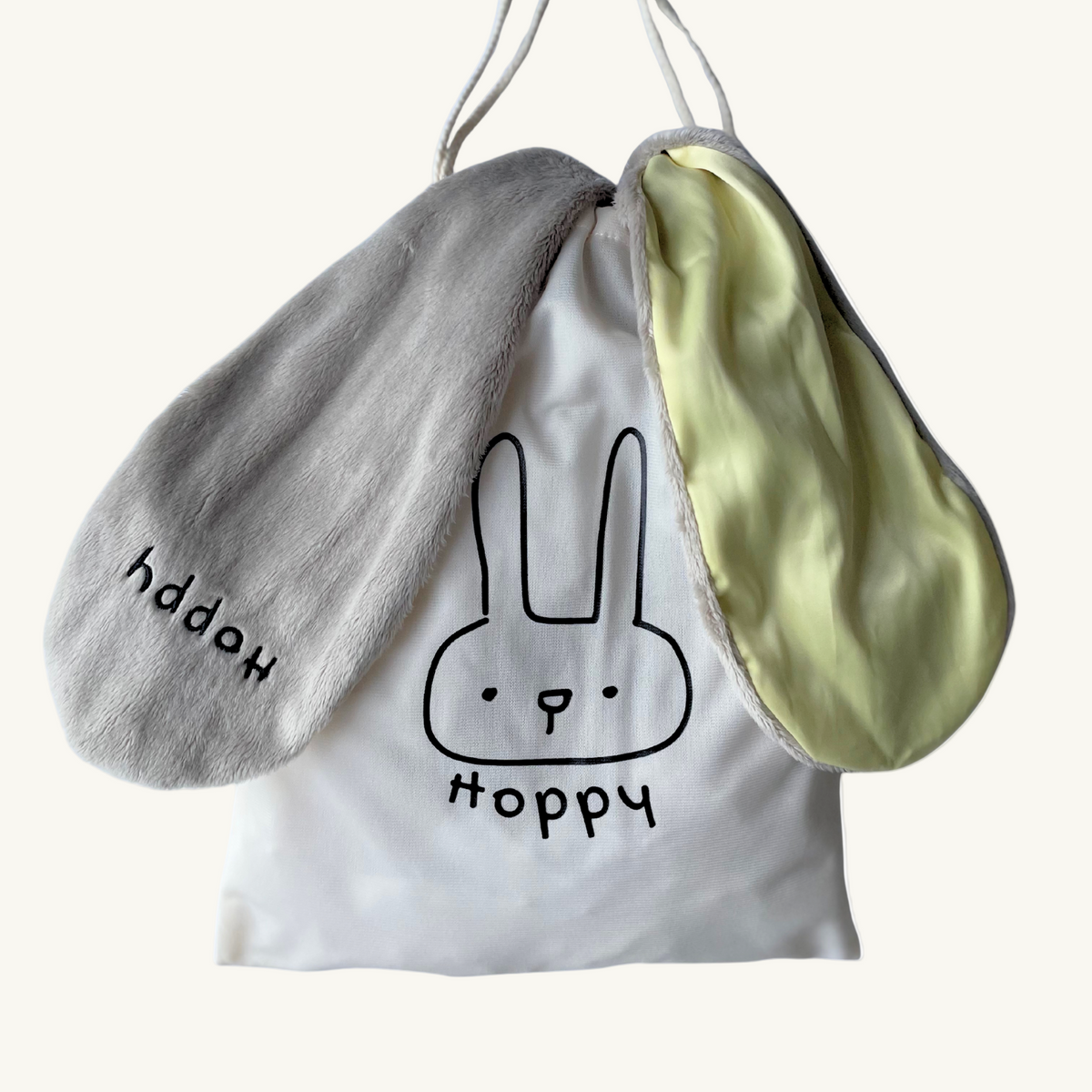 Sunny Hoppy baby lovey bunny packaged in a reusable drawstring cotton bag, ideal for gifting.