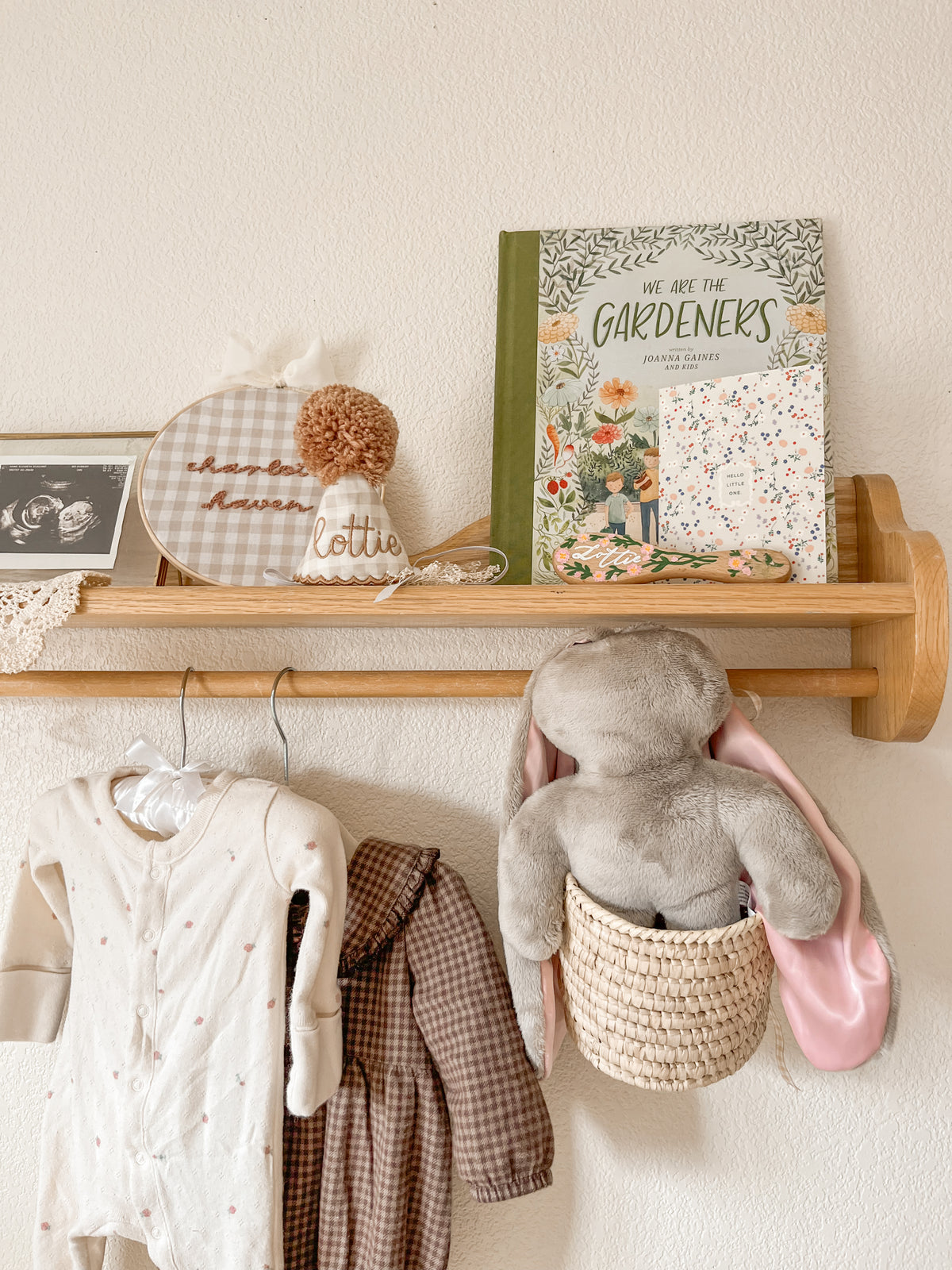 Soft Hoppy baby lovey bunny stored in a woven basket on a nursery wall shelf, blending comfort with thoughtful nursery decor.
